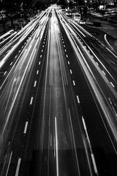 Long exposure of traffic lights on a Buenos Aires street at night, capturing urban energy.