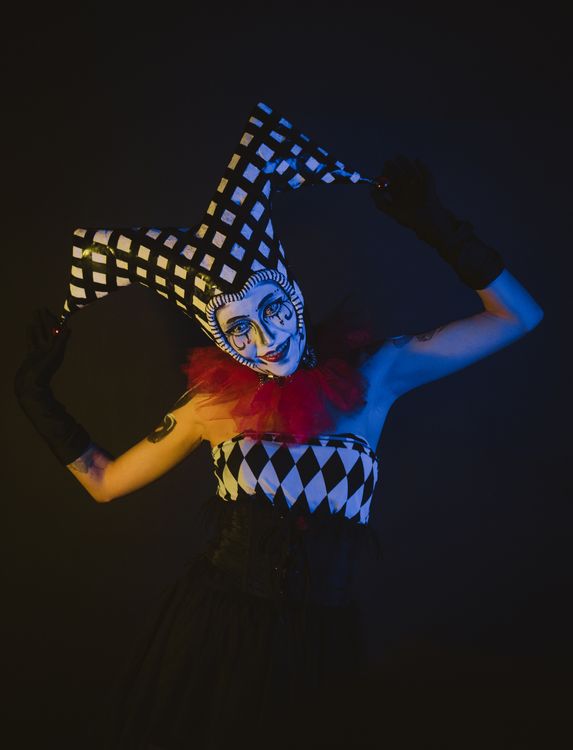 Jester Color Themes Colorful Jester Costume Portrait in Dramatic Lighting · Free Stock Photo