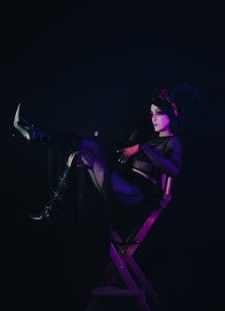 A woman in a dark costume poses with demonic horns, exuding a gothic and eerie atmosphere.