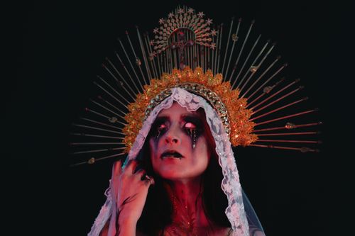 Free A hauntingly beautiful woman in intricate costume evokes a gothic Halloween vibe. Stock Photo