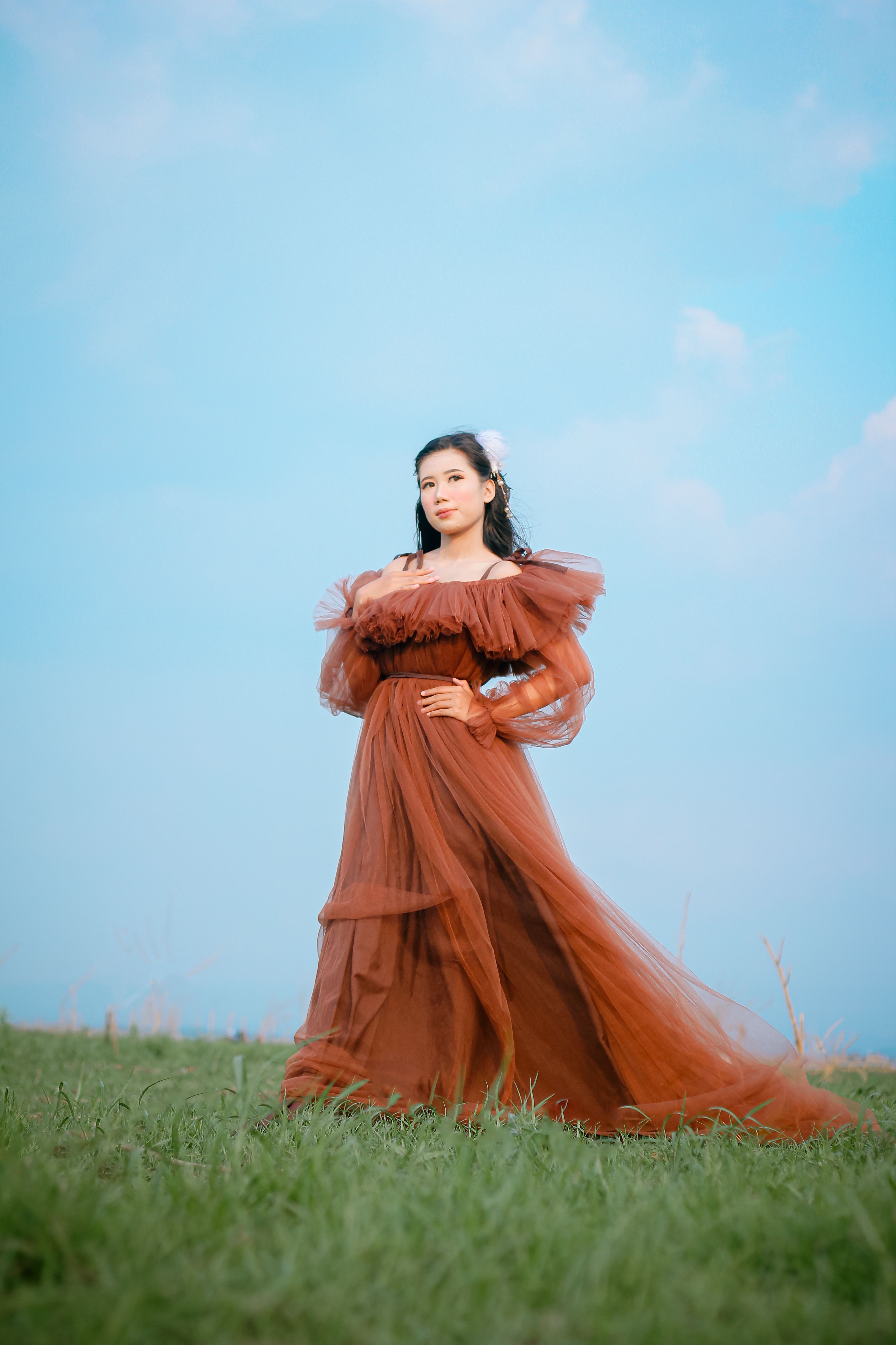 Elegant Woman in Flowing Dress Outdoors  Free Stock Photo