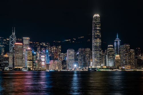 Free Captivating night view of Hong Kong's skyline reflecting over Victoria Harbour. Stock Photo