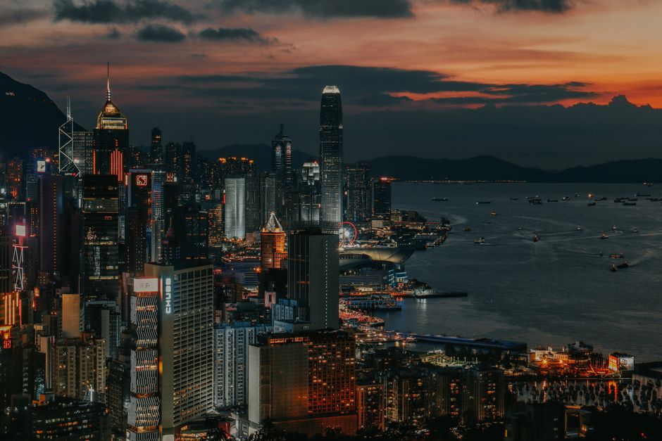 Captivating night view of Hong Kong's skyline with illuminated skyscrapers and waterfront.