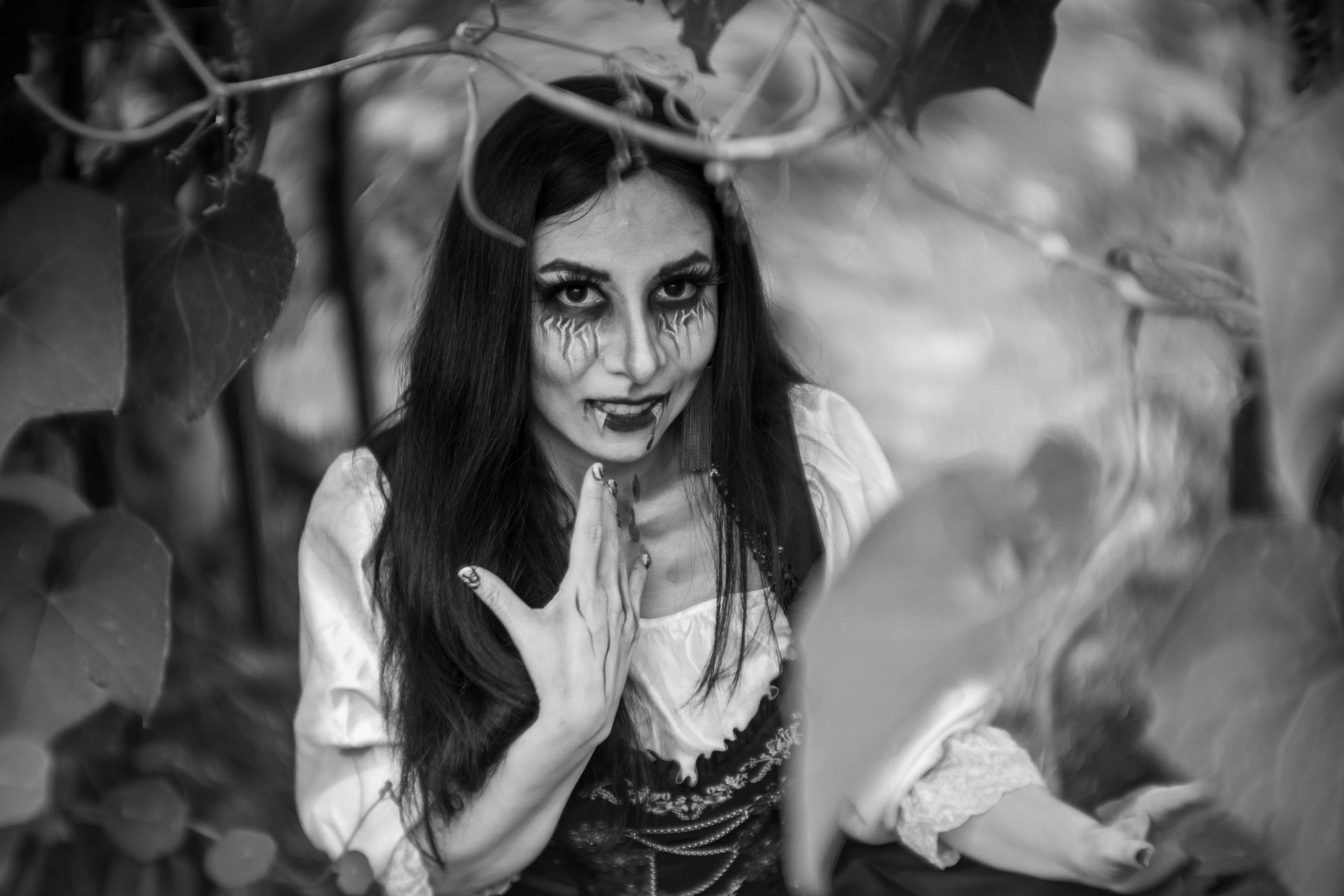 spooky woman in black and white forest setting