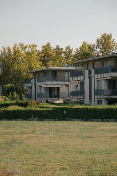 Scenic view of a modern apartment complex amidst lush greenery in Hungary.