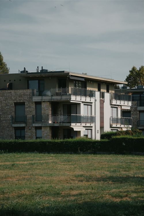 Free A contemporary apartment building set amidst greenery in Hungary, showcasing modern architecture. Stock Photo