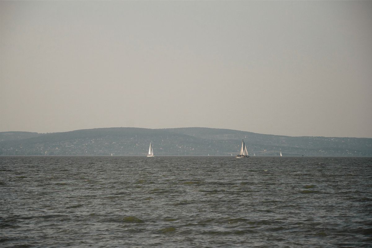 Sailboats on Lake Balaton with distant hills on the far shore