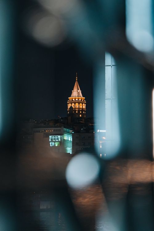 Free A night view of the historic Galata Tower in Istanbul, framed through an artistic blur. Stock Photo