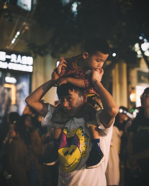 Man Carrying Boy on His Shoulder