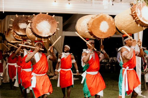 Free Vibrant dance group performing with large, traditional African drums at an event. Stock Photo