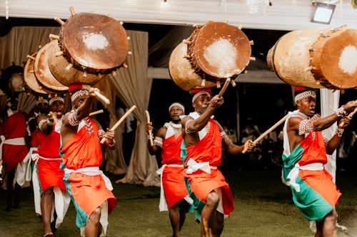 Free Vibrant display of cultural dance and drum performance by African men indoors. Stock Photo