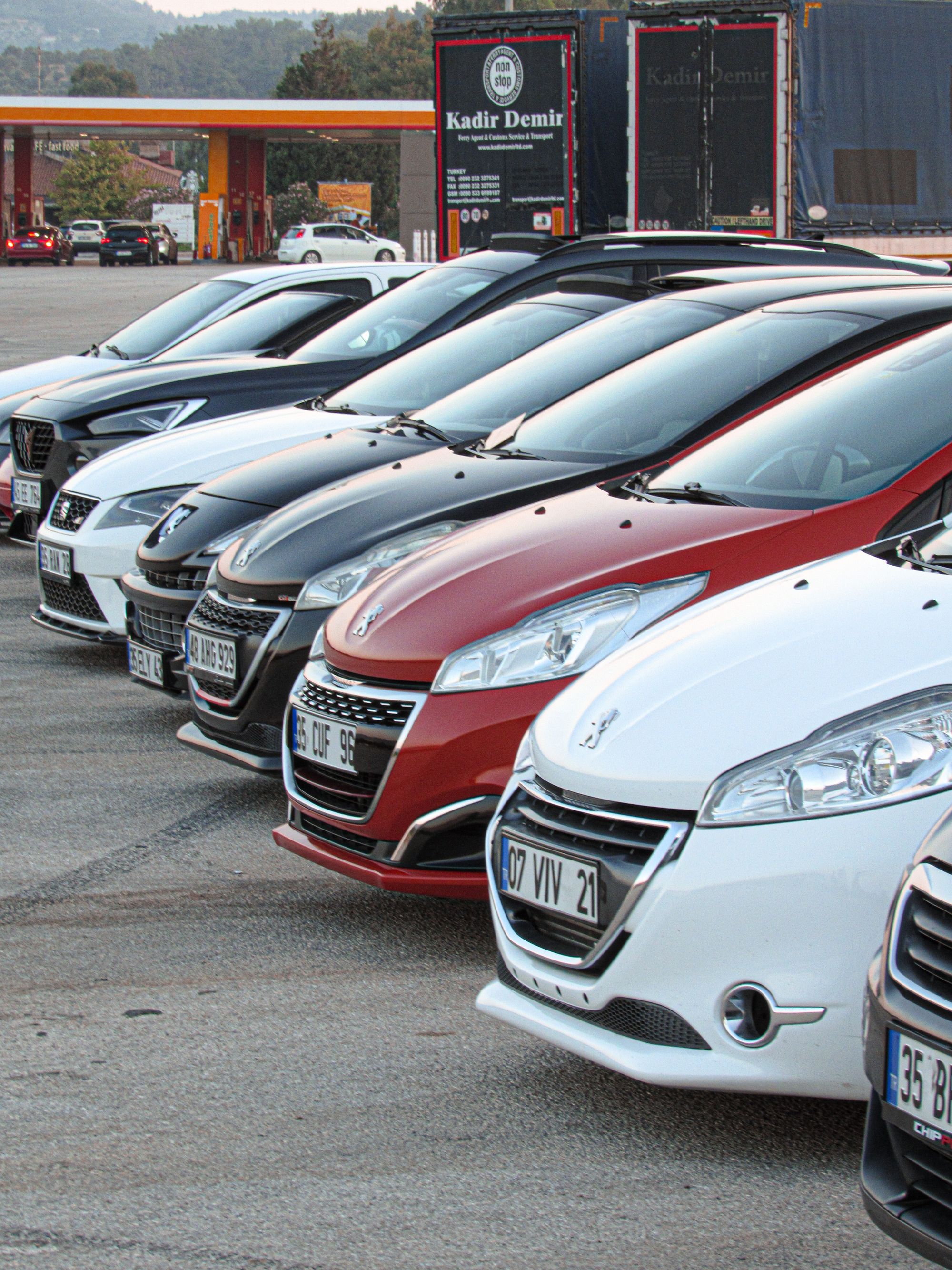 Shows a lineup of Peugeot vehicles at a dealership, directly relevant to the multi-model recall affecting Peugeot among…