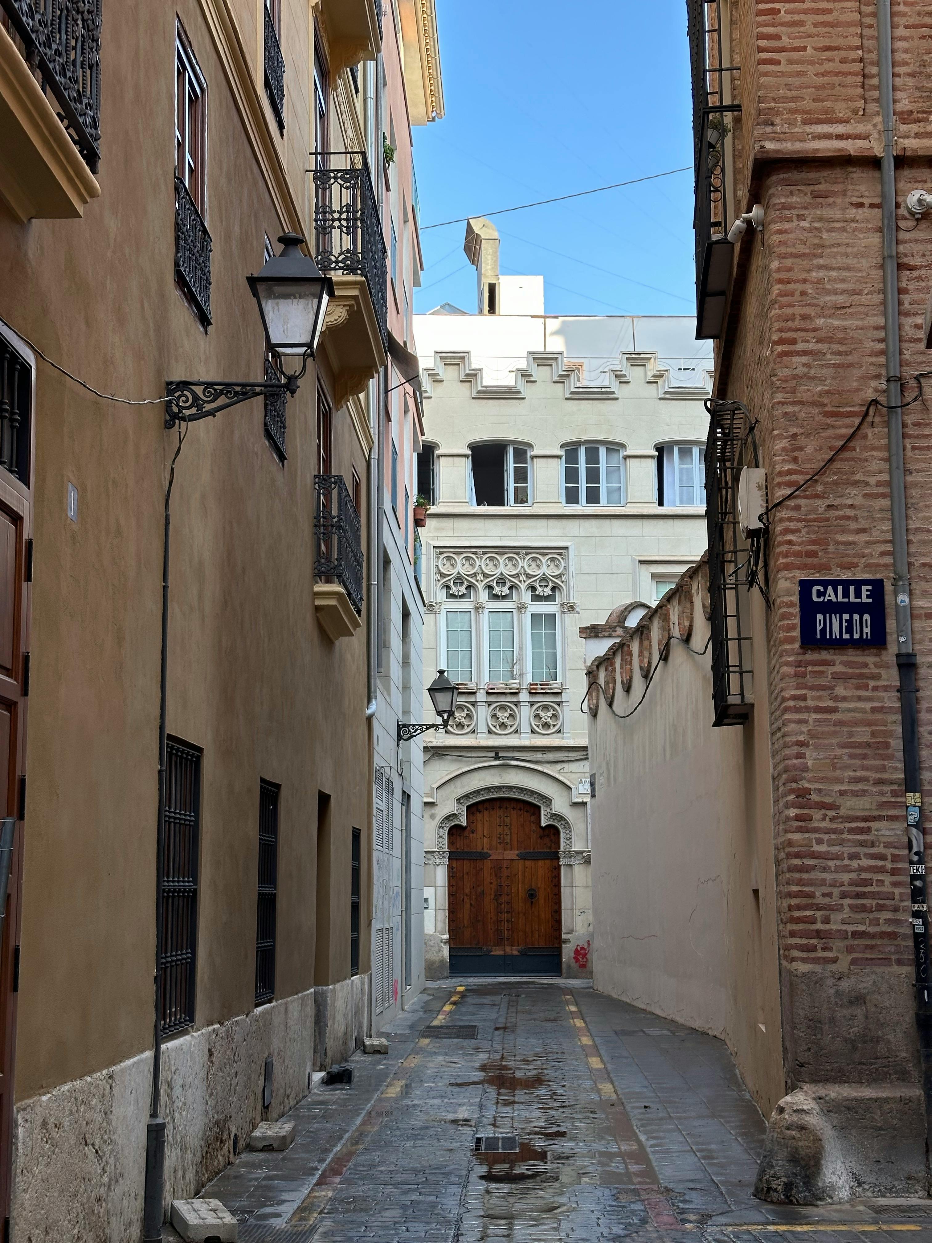Charming narrow alleyway in Valencia showcasing historic European architecture.