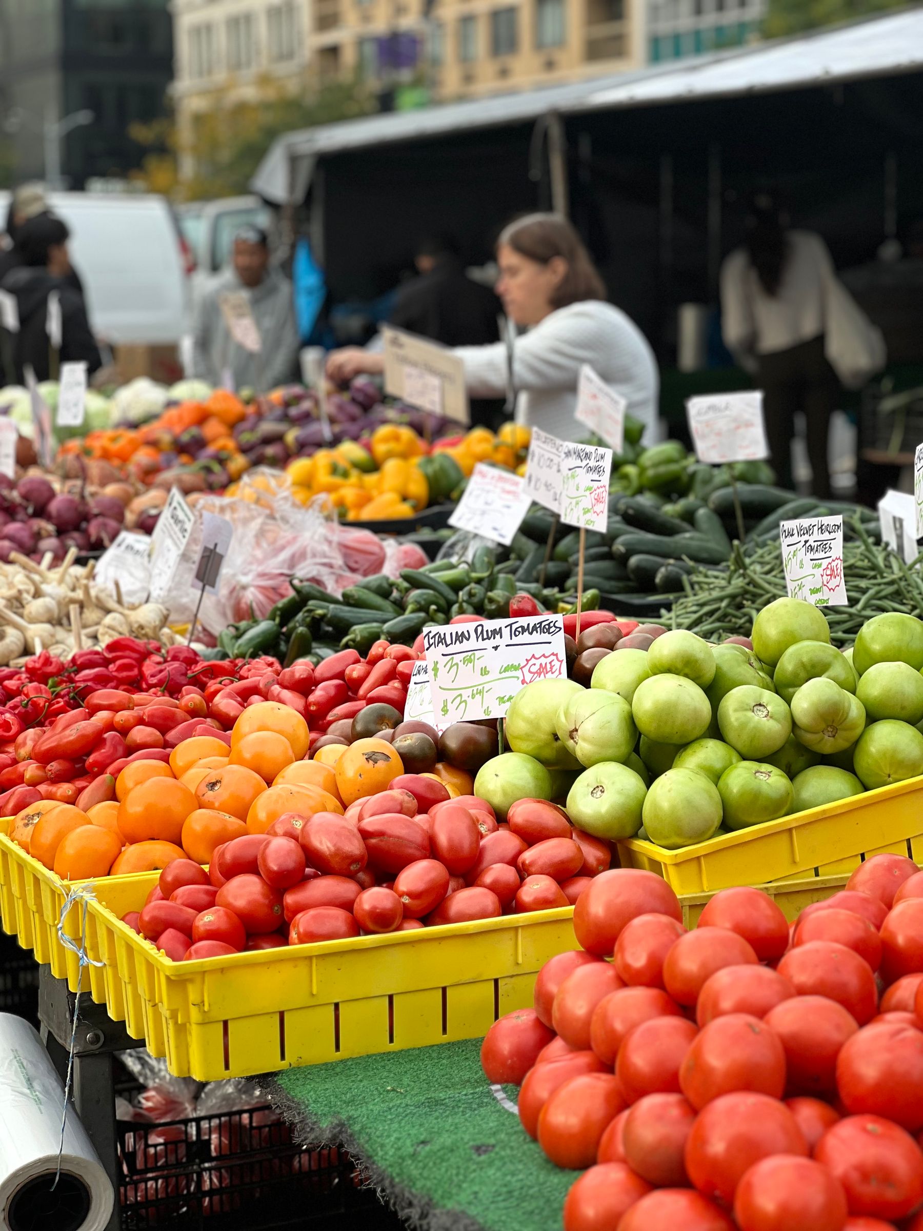 Open-air farmers market with fresh produce displays