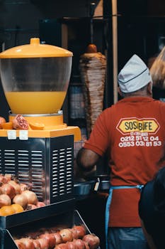 A street food vendor prepares delicious kebabs in Istanbul, Türkiye, at a vibrant market stall.