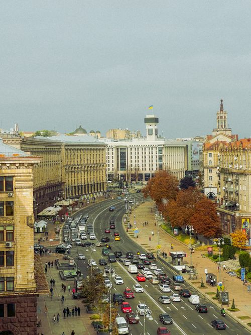 Free A vibrant autumn day in Kyiv capturing historic architecture and bustling traffic. Stock Photo