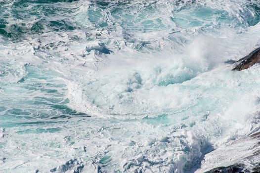 海浪撞击岩石，激荡出充满活力的碧绿色海水