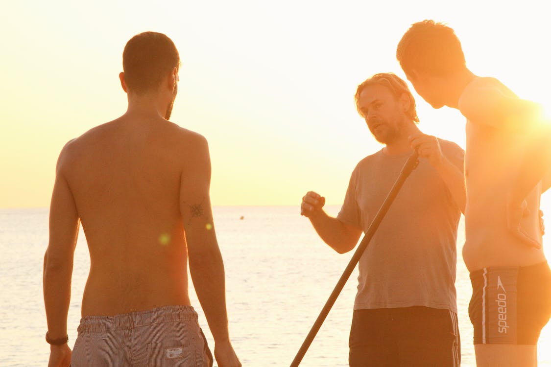 Men Standing Near Sea