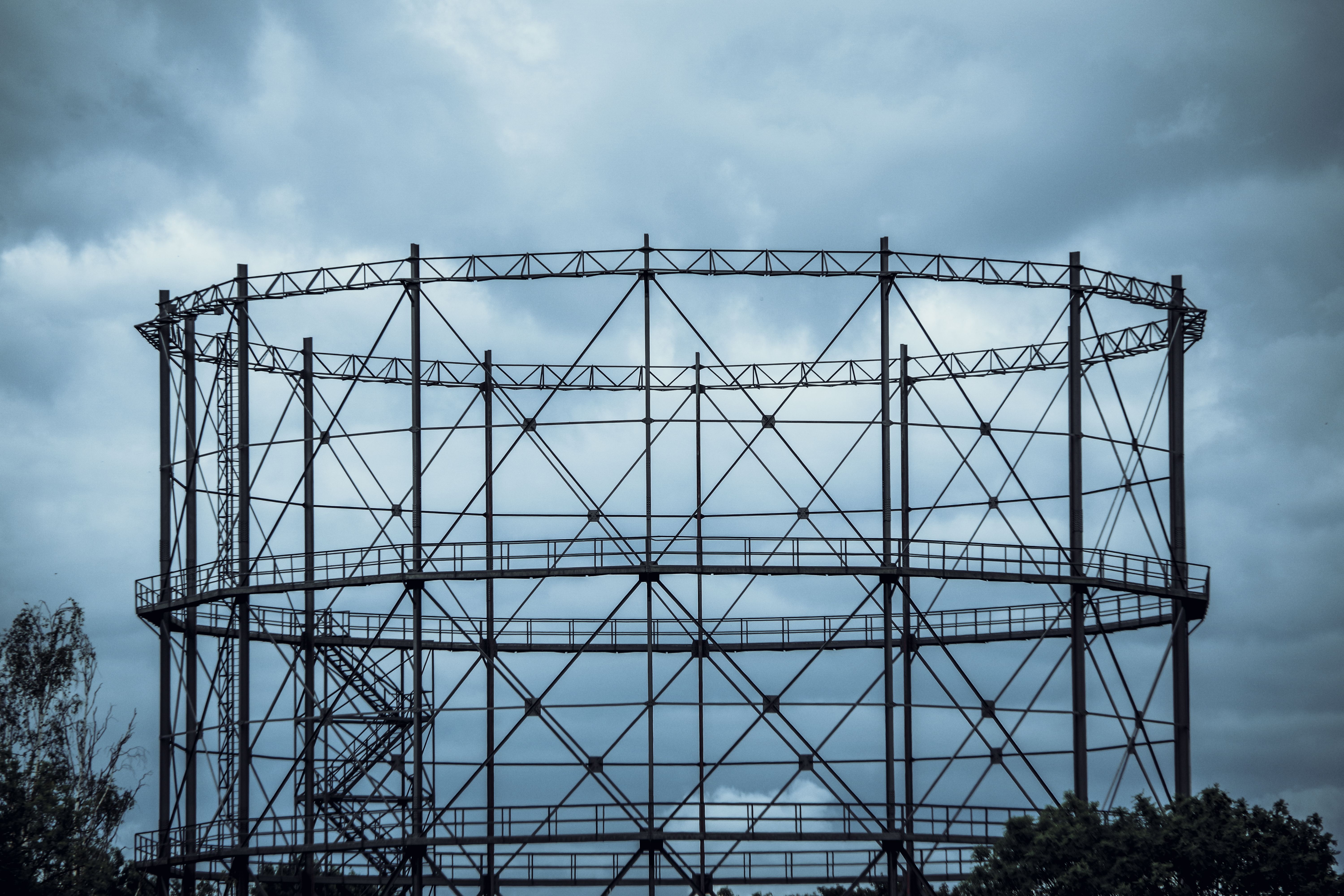 Industrial Gasometer Against Cloudy Sky · Free Stock Photo