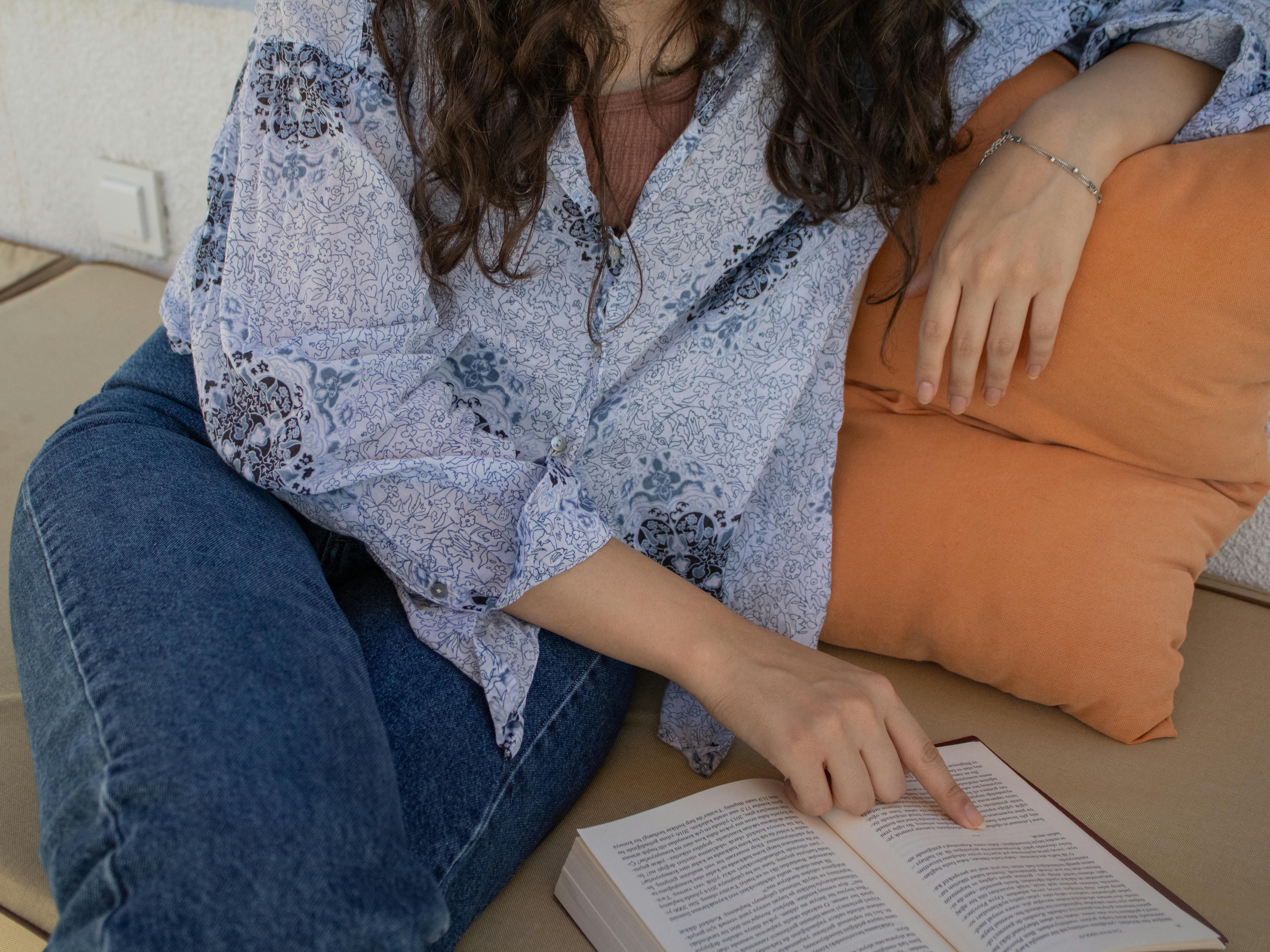 Young Woman Reading a Book in Cozy Setting