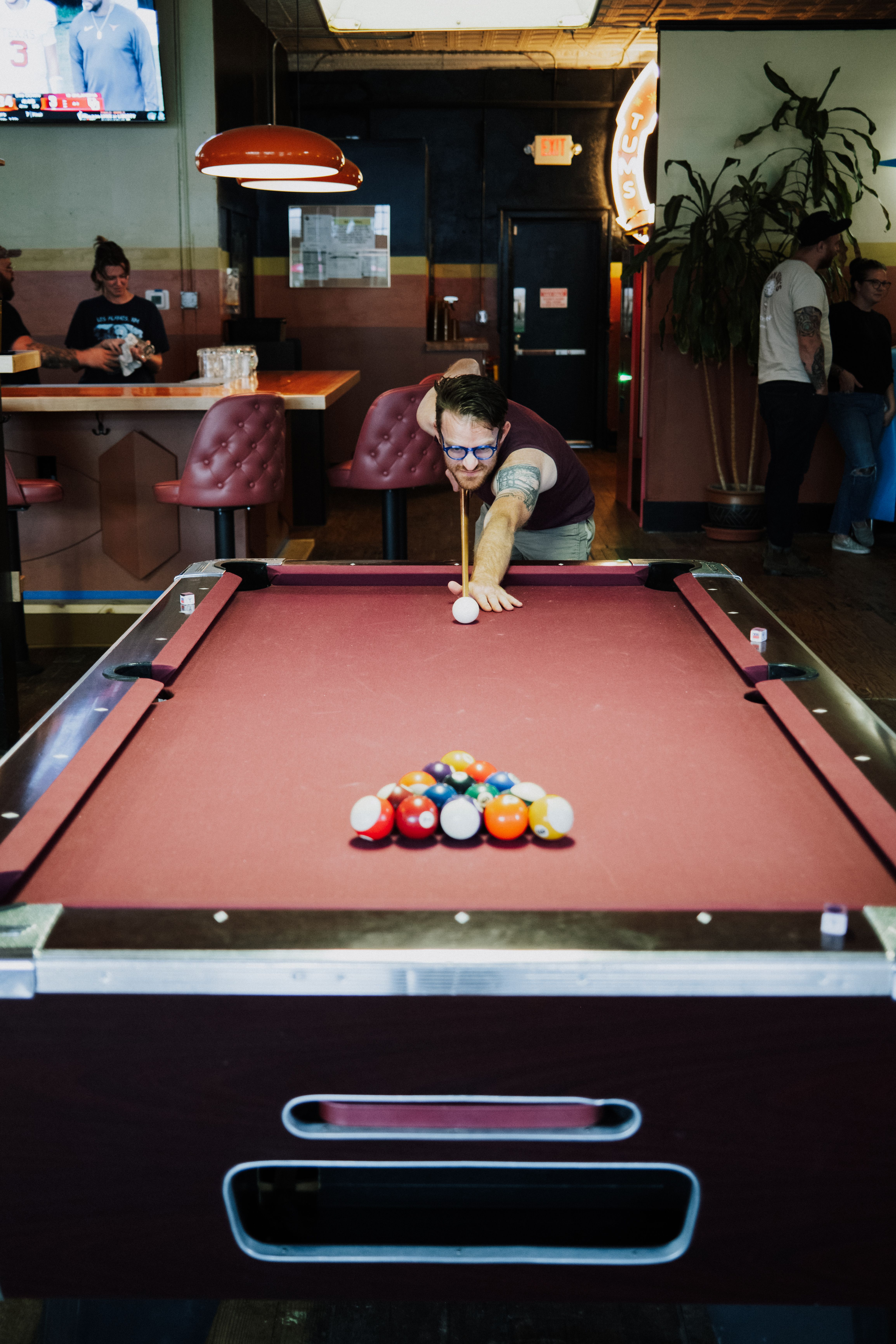 Man playing pool in vintage bar setting · Free Stock Photo