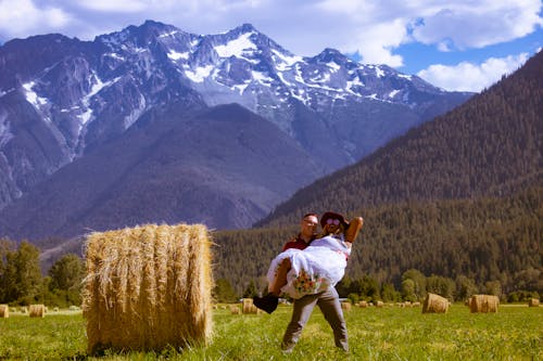 Free Man Carrying Woman In The Hay Field Stock Photo