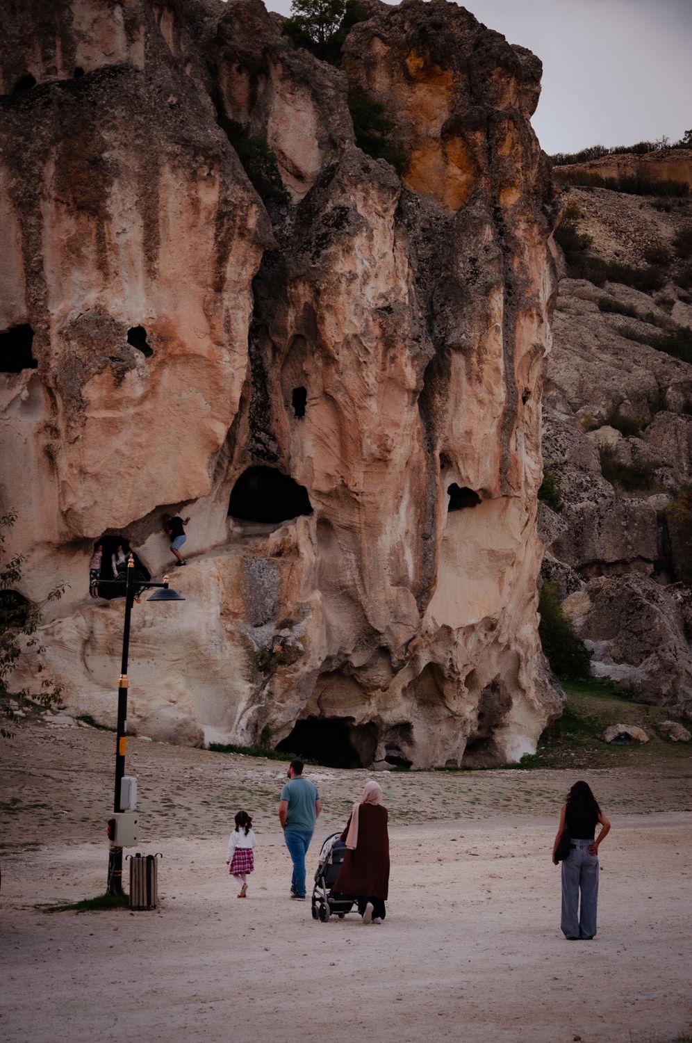 People Walking Near Ancient Rock Formations · Free Stock Photo