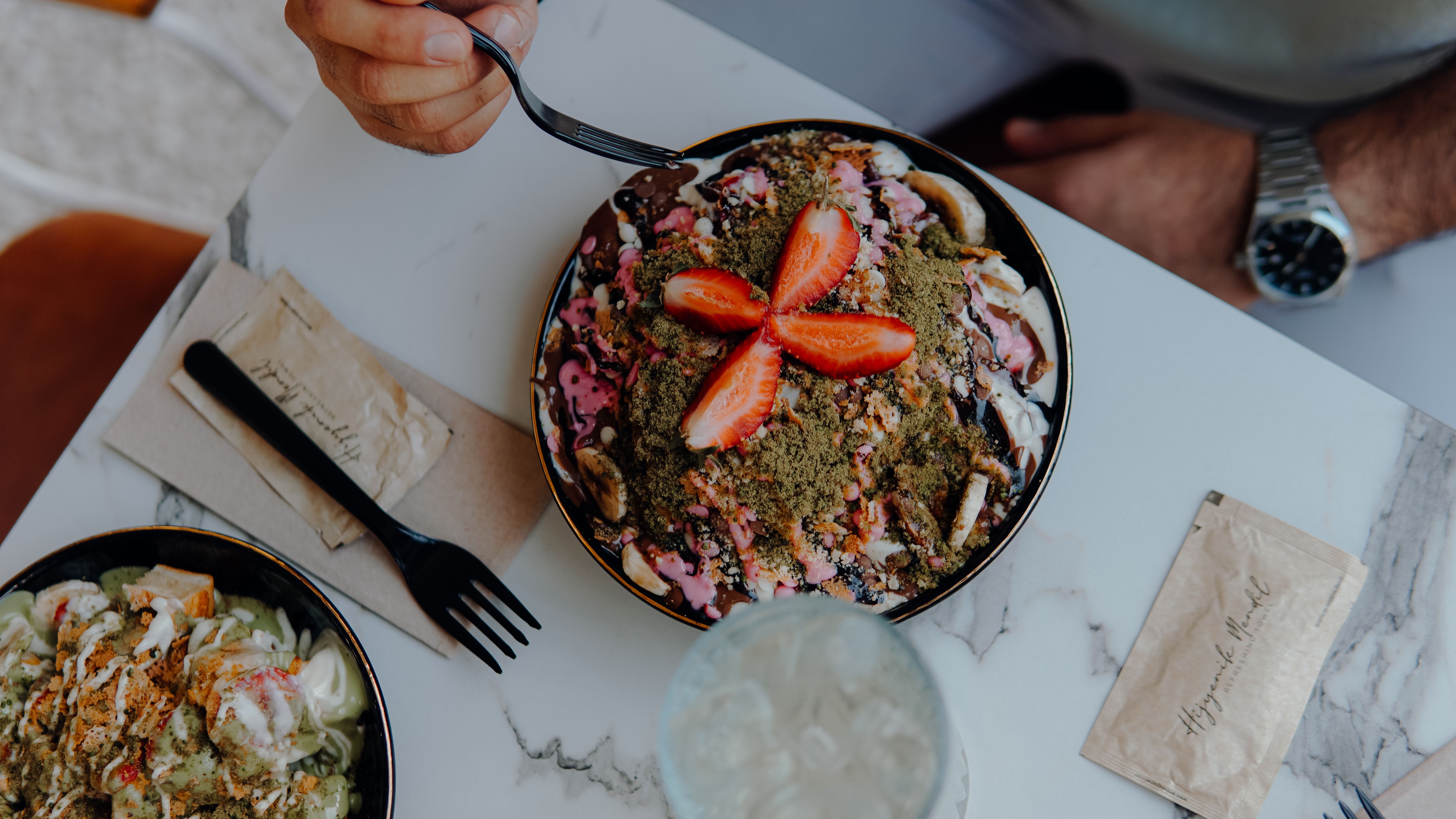 Top view of a dessert bowl with fresh strawberries, perfect for food enthusiasts.
