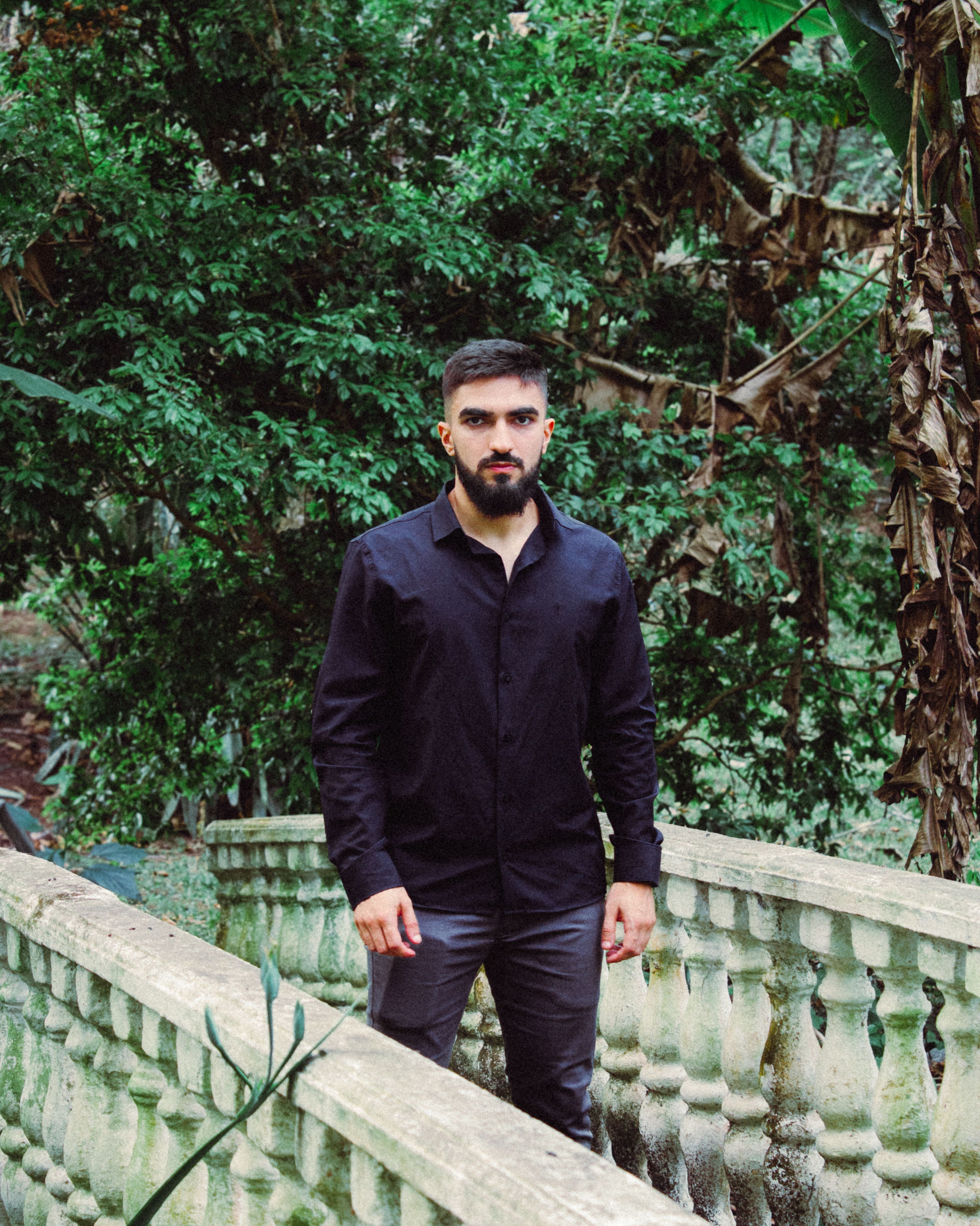 Young Man on Historic Stone Bridge in Forest · Free Stock Photo