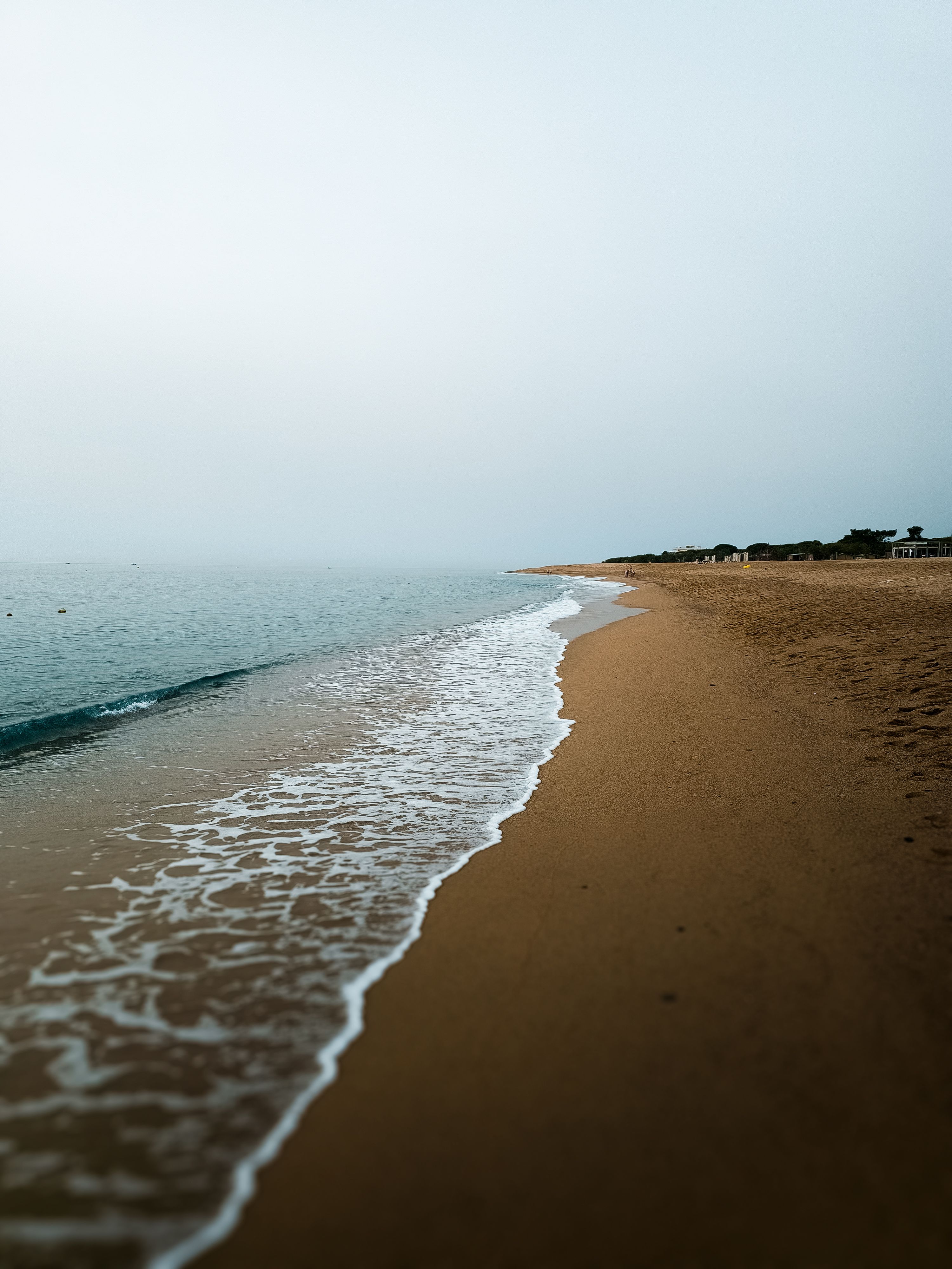 Tranquil beach waves meeting the shore in Santa Susanna, Catalunya.