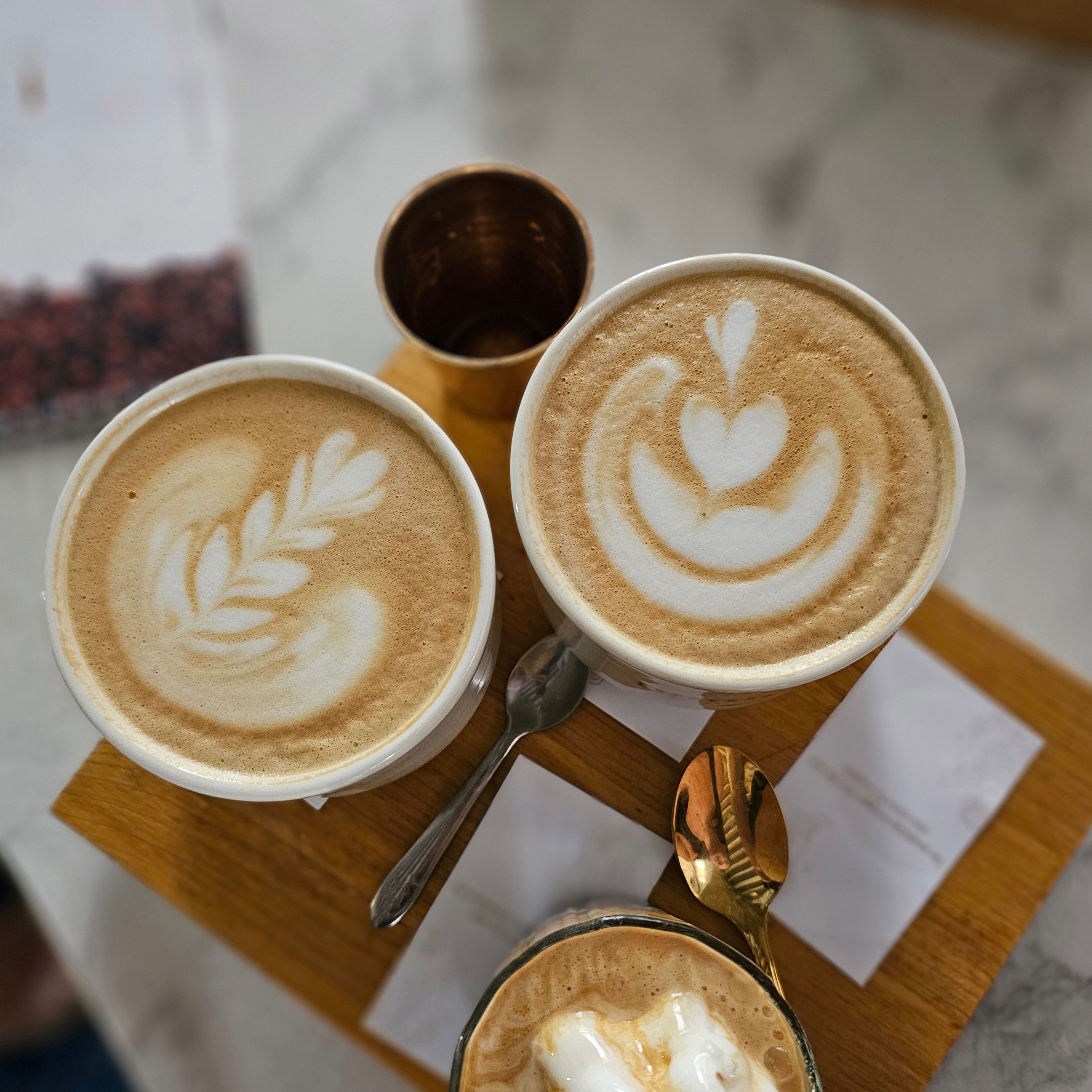Artistic Latte Art with Heart and Leaf Designs