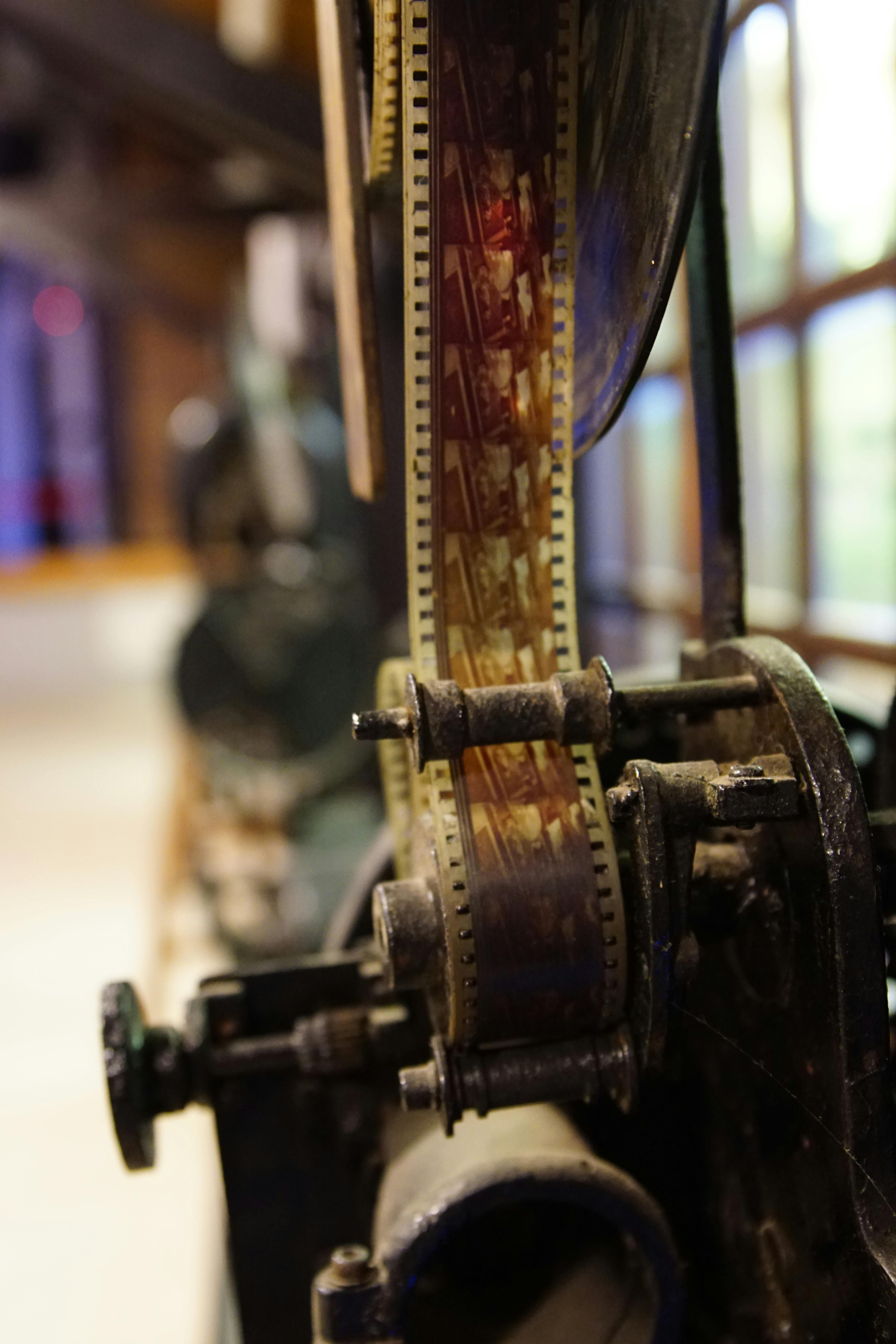 old movie projector with film roll in museum