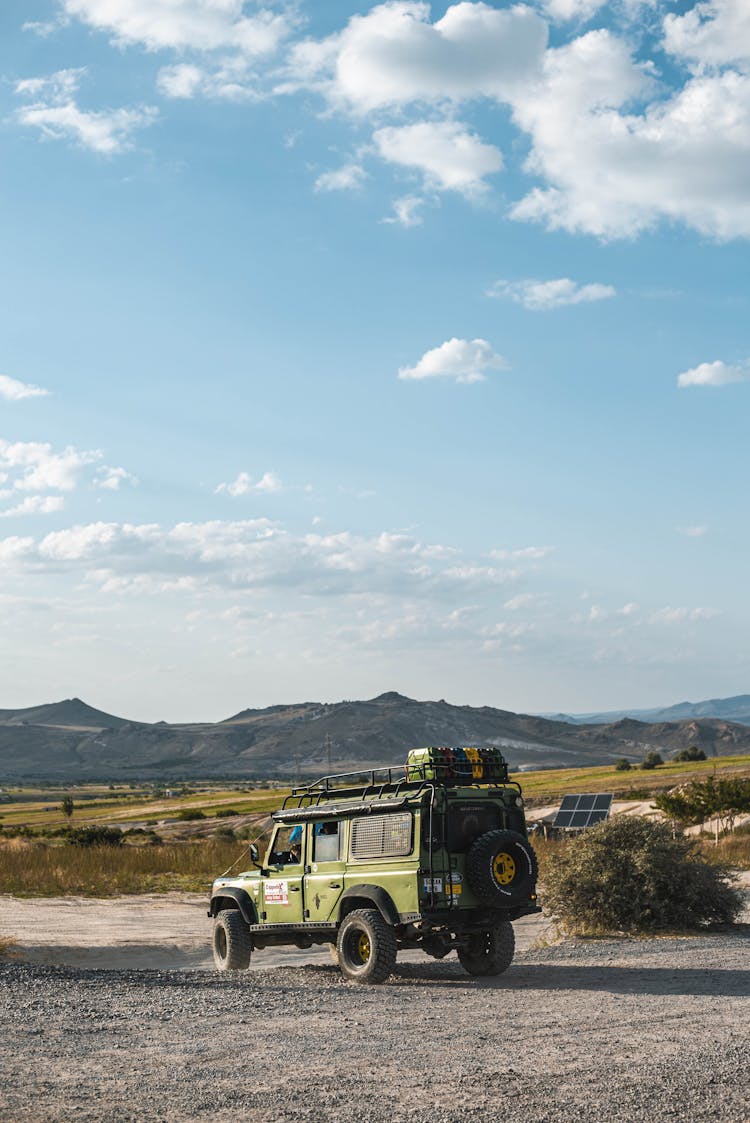 Green Jeep Parked On Dirt Road