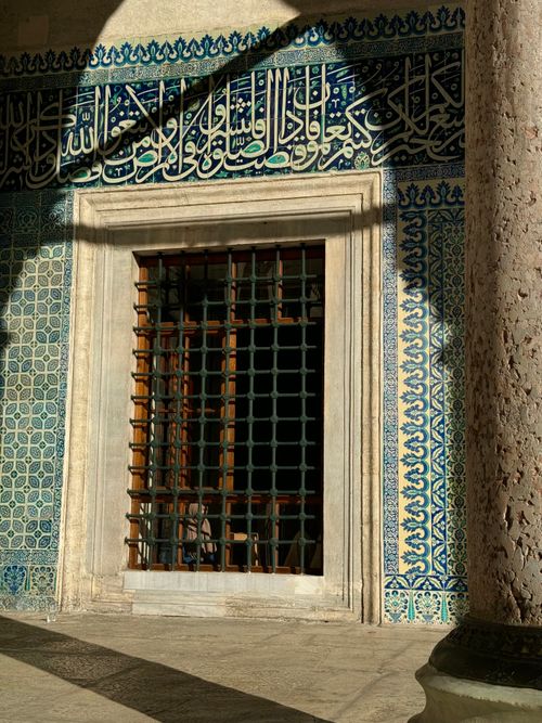Free Exterior view of historic Islamic architecture featuring intricate blue tiles and calligraphy. Stock Photo