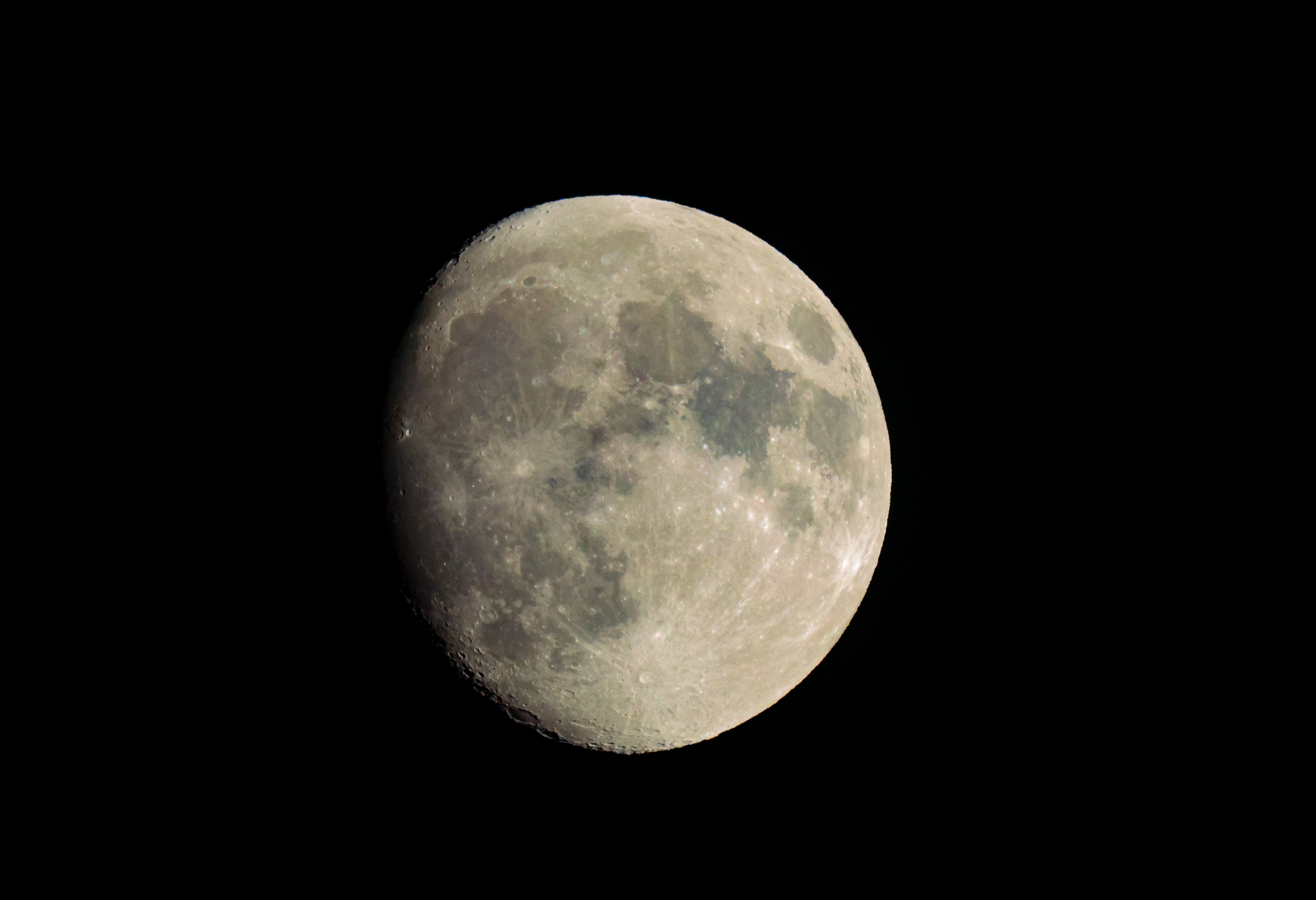 Beautiful waxing gibbous moon shining brightly against the night sky in Darien, Connecticut.