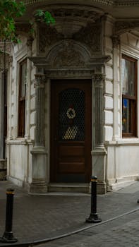 Charming old building entrance with intricate stonework and a wooden door.