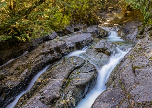 Free Tranquil scene of a waterfall cascading through rocks in Skykomish, Washington forest. Stock Photo