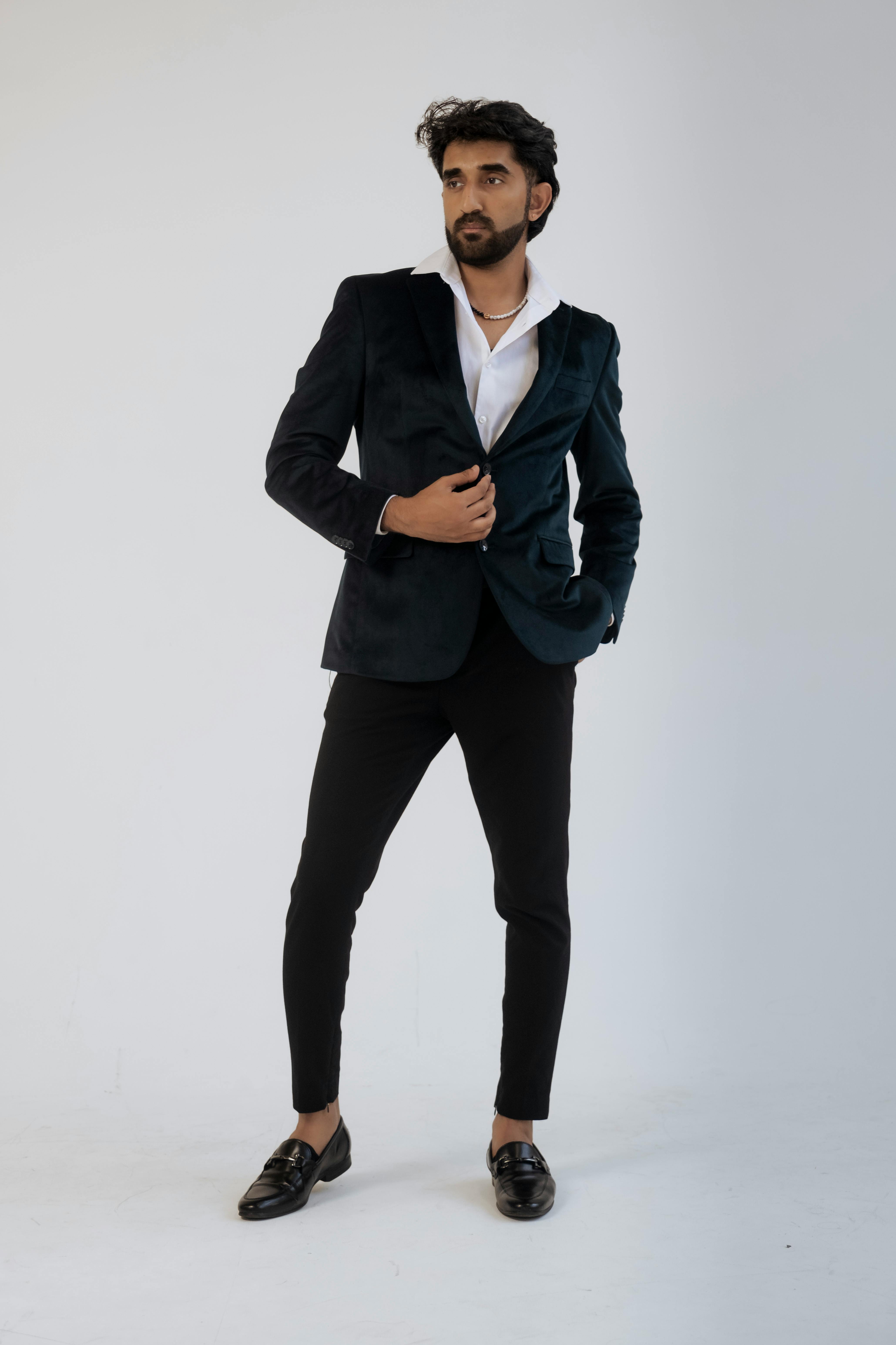 Free Stylish man posing in black suit with white shirt, showcasing modern men's fashion. Stock Photo