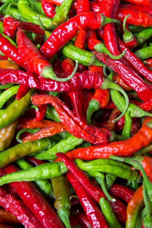 Free Pile of Red and Green Chili Peppers Stock Photo