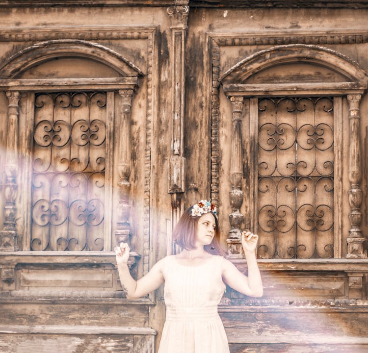 Woman Leaning On An Old Wooden Door