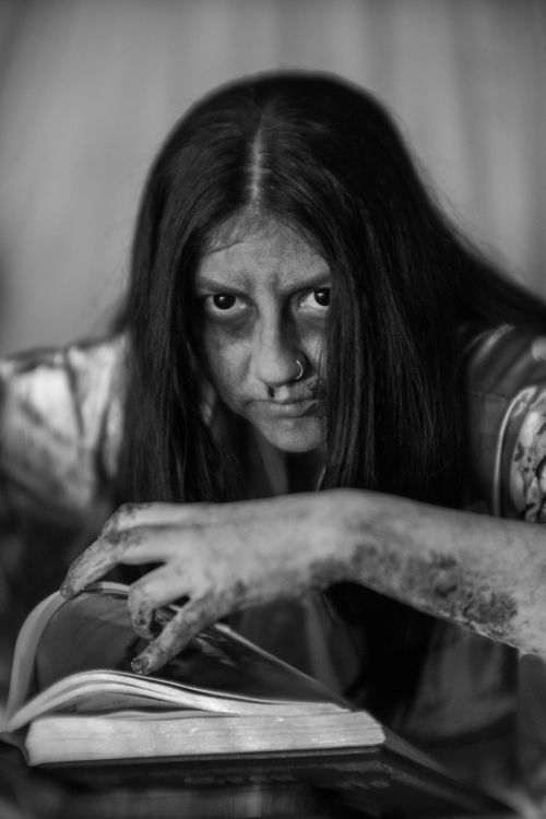 Free Black and white portrait of a person with eerie Halloween makeup, creating a haunting mood. Stock Photo