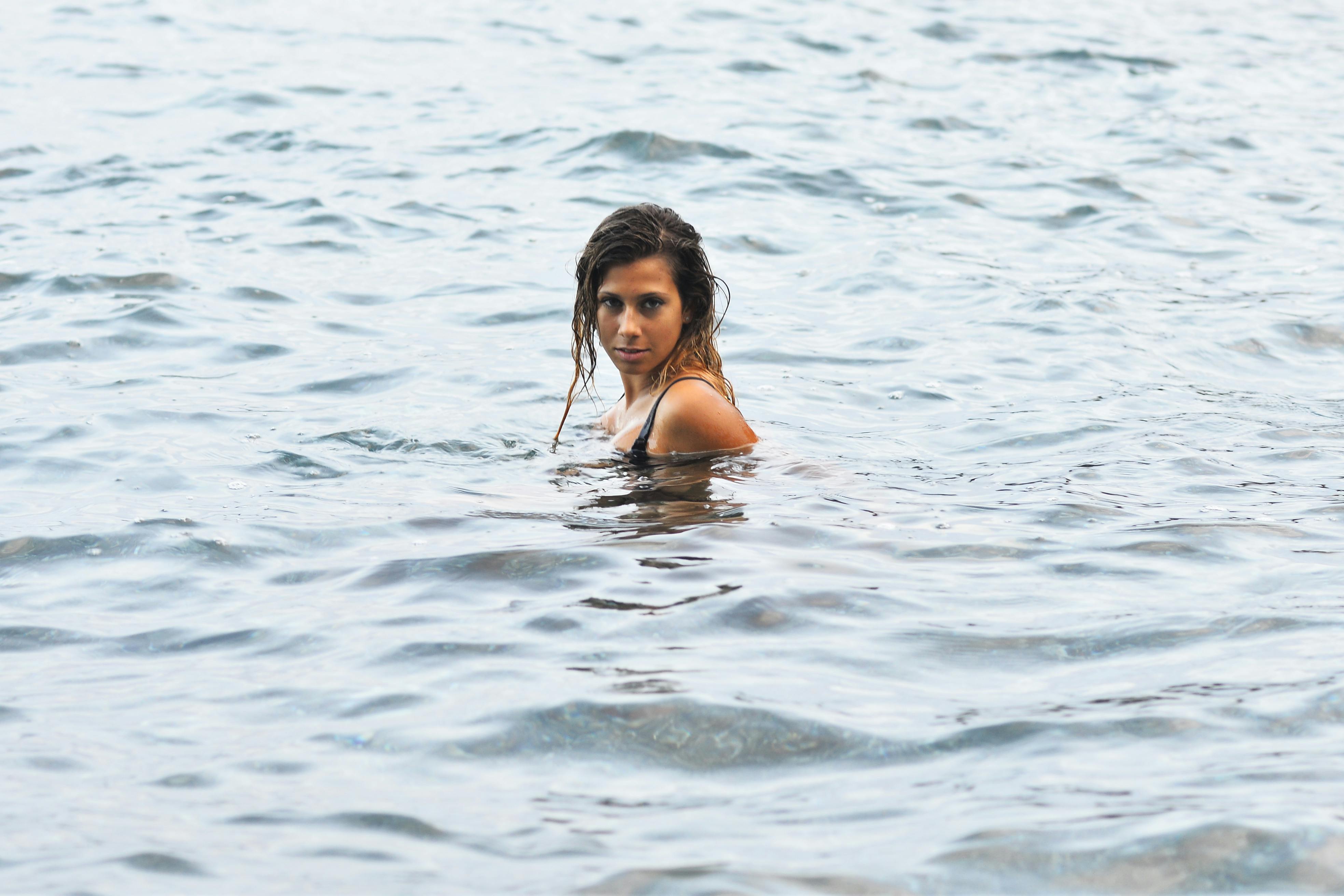 woman swimming in open water on a summer day