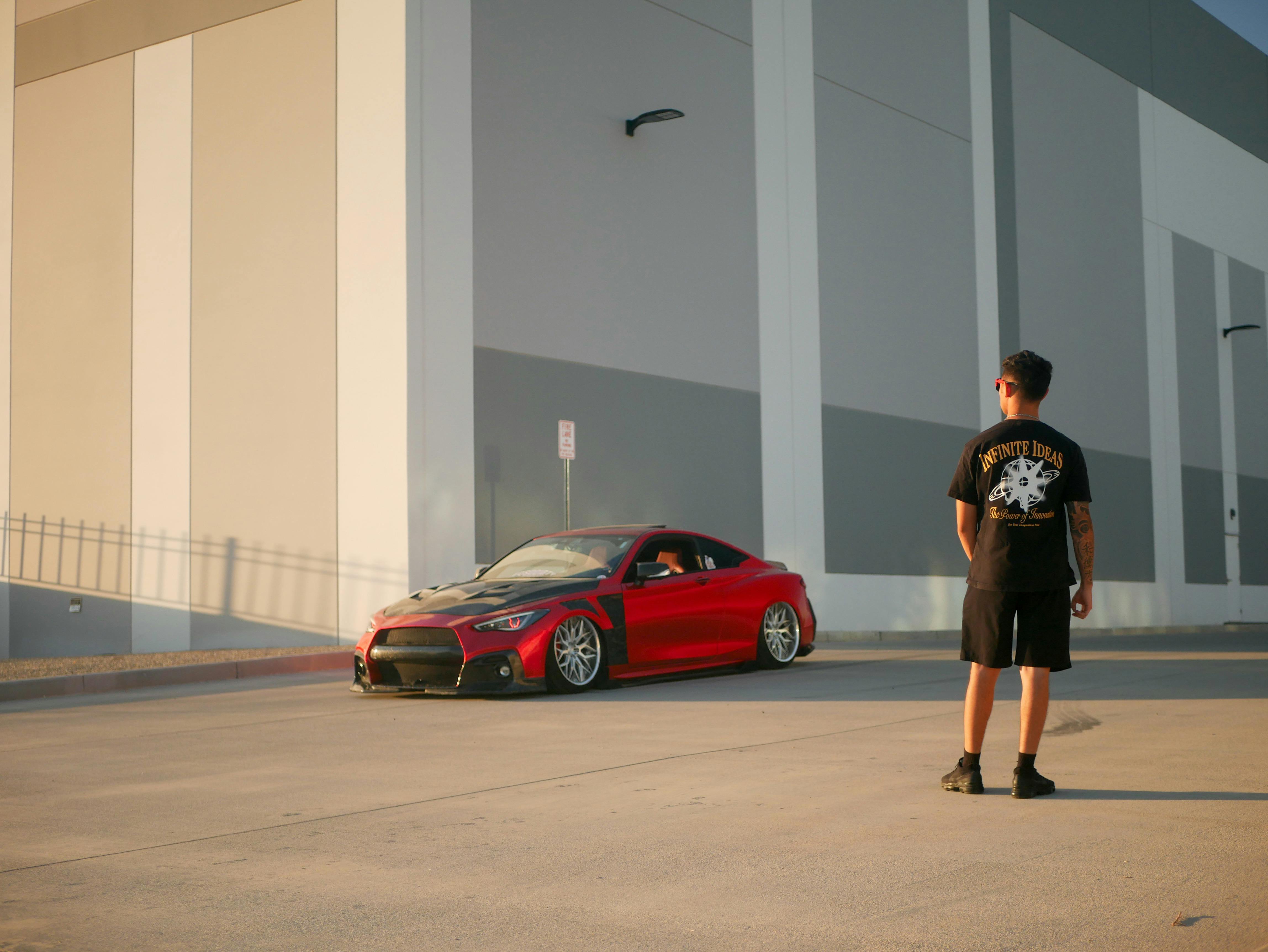 stylish red car parked by a modern building