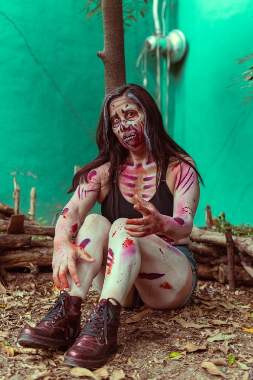 Free Young woman in zombie makeup outdoors, perfect for Halloween or cosplay themes. Stock Photo