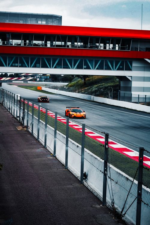 Free Sports cars racing at Circuit de Catalunya in Spain with dynamic speed and energy. Stock Photo