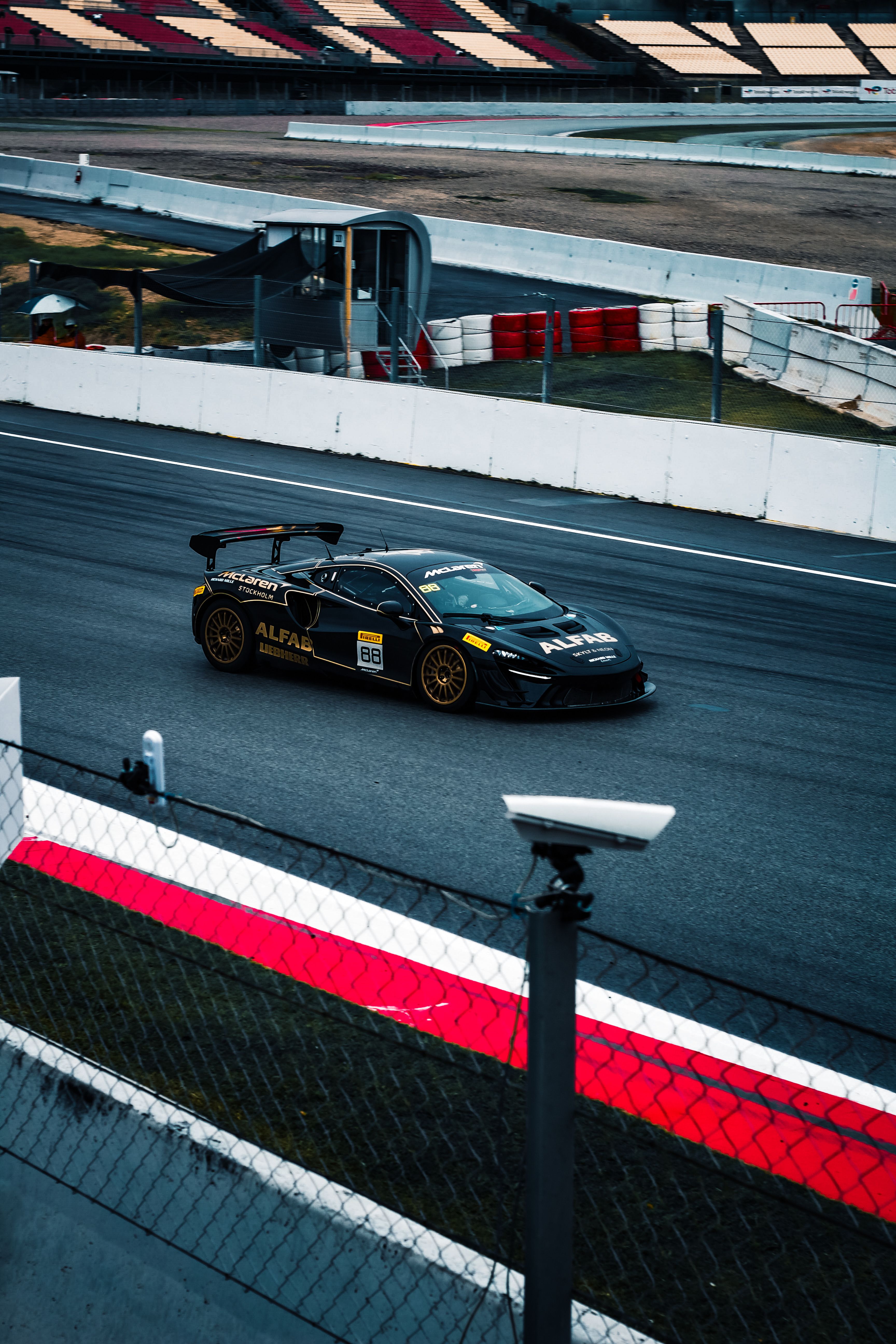 High-Speed Sports Car Racing at Circuit · Free Stock Photo