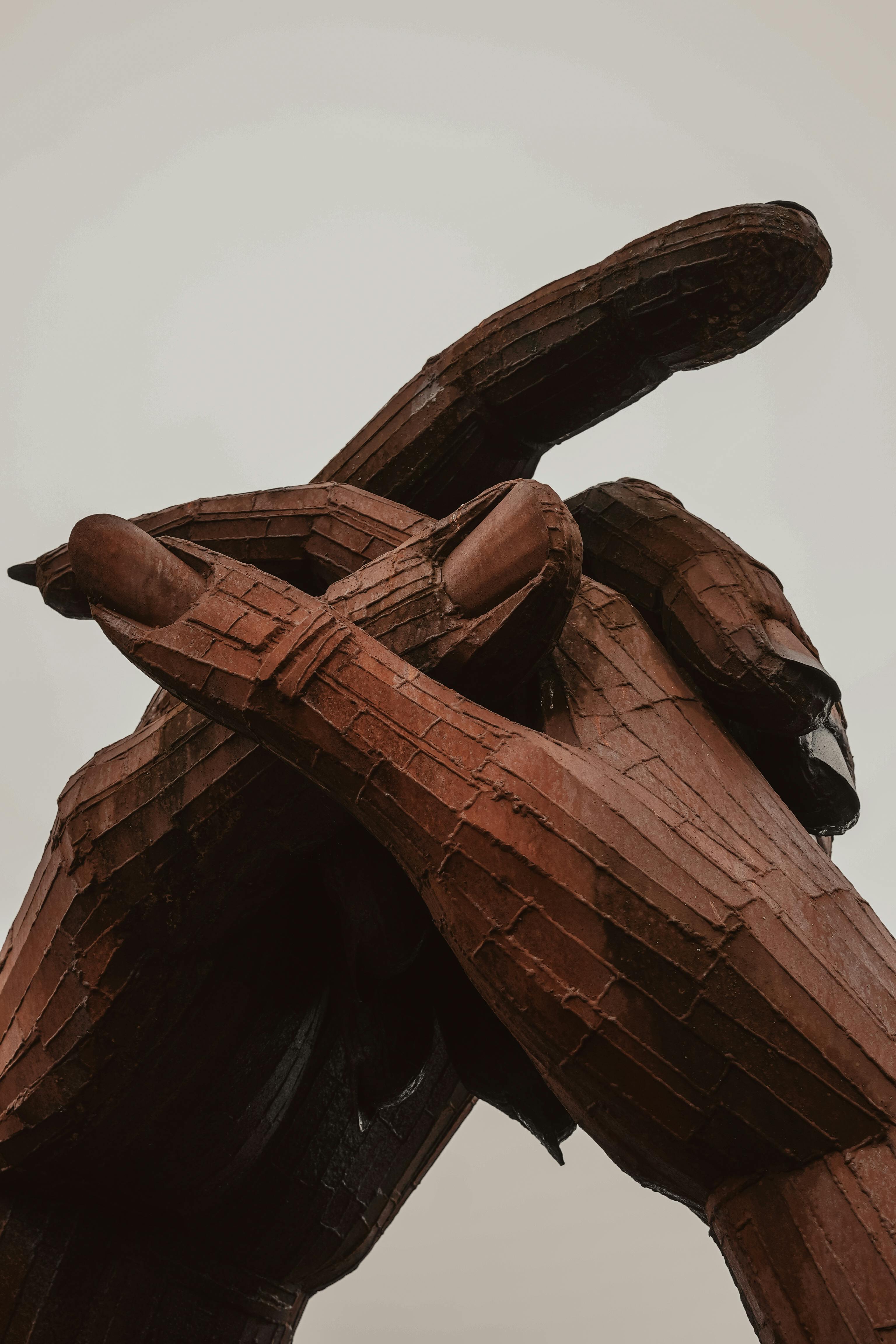 Wooden sculpture of two hands embracing, symbolizing love and unity in Gretna Green, Scotland.