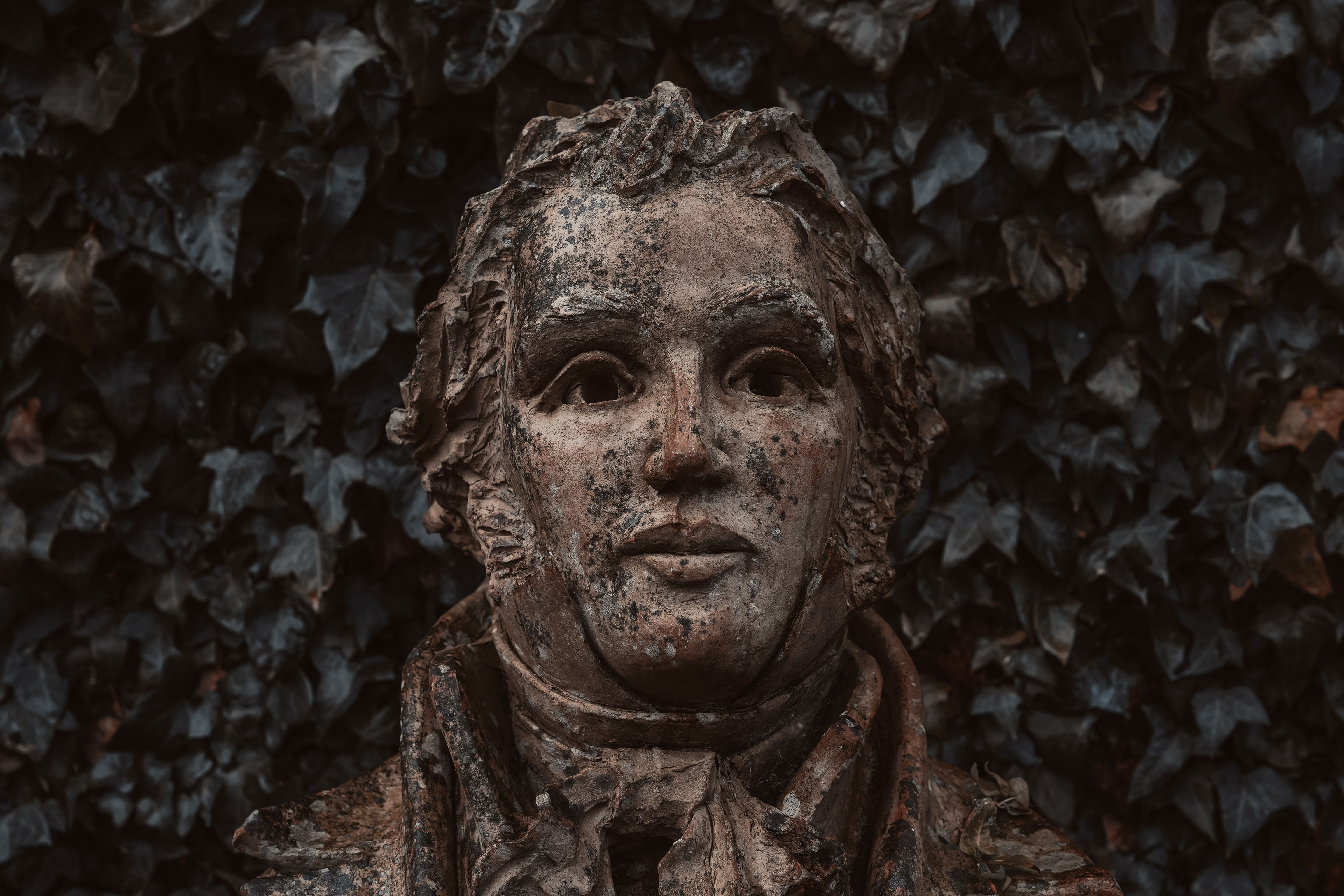 Enchanted sculpture surrounded by dark ivy in Gretna Green, Scotland.
