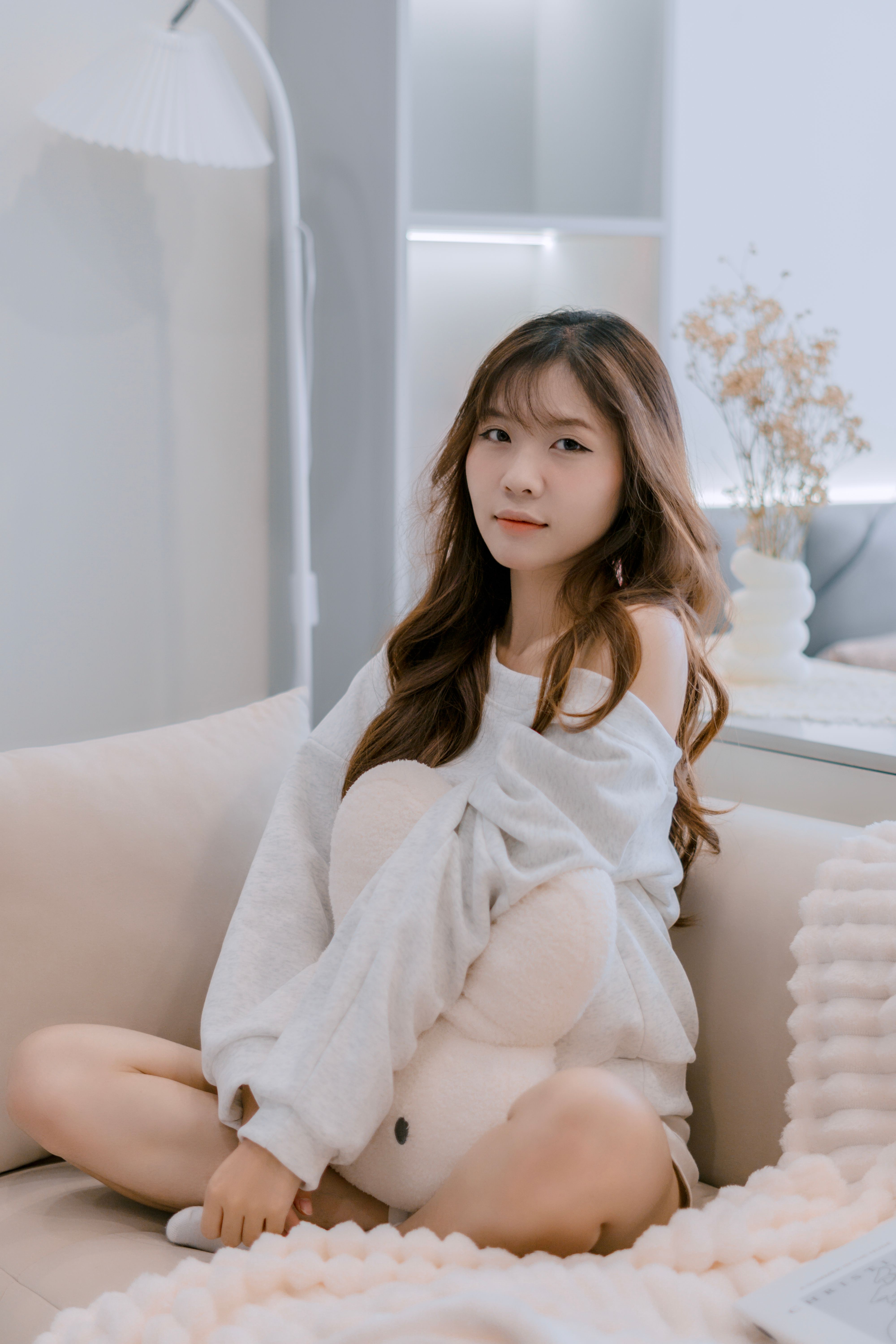 Young woman relaxing indoors, creating a serene and cozy atmosphere.