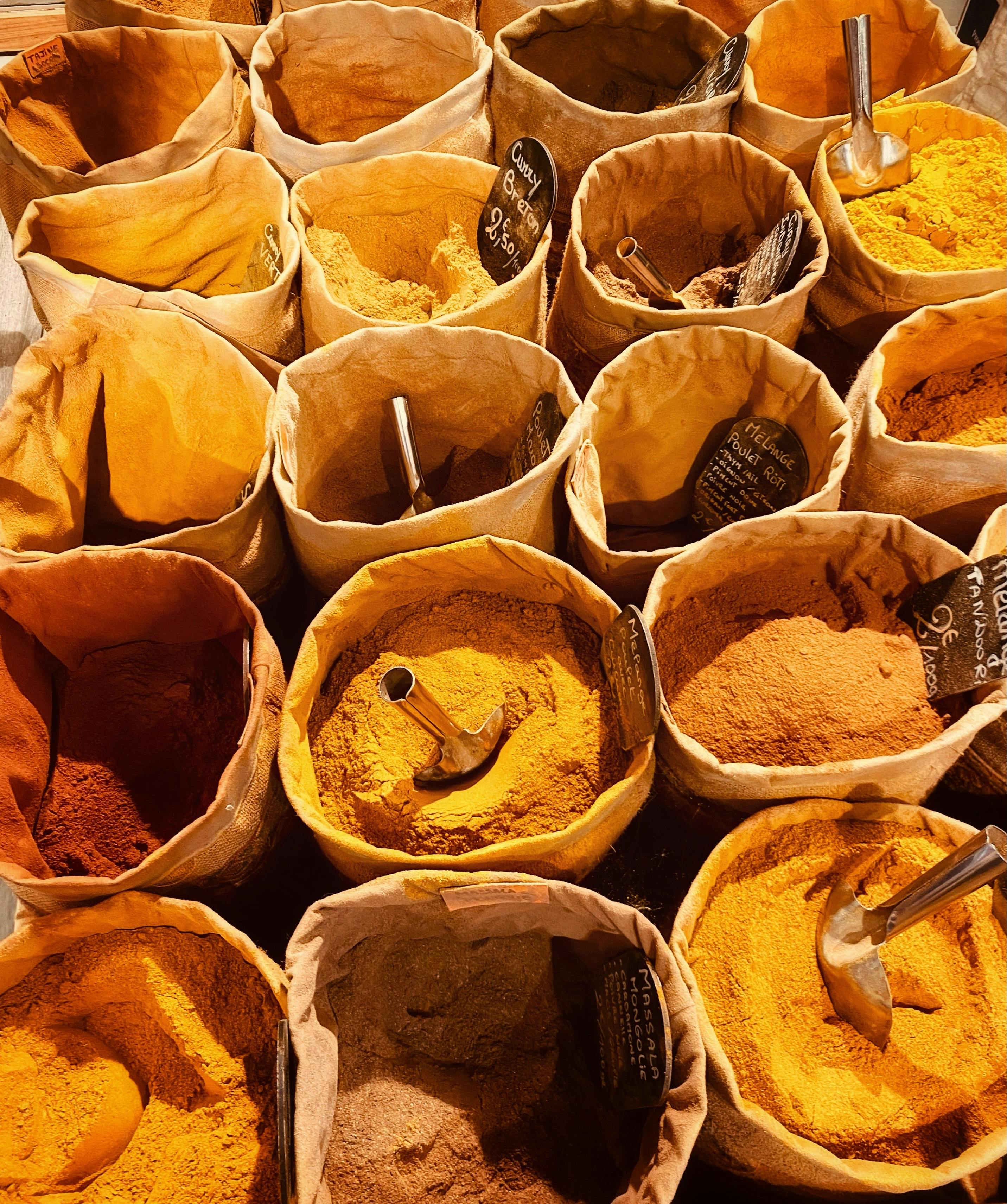 A vibrant display of spices in sacks at a market in Marseille, France.